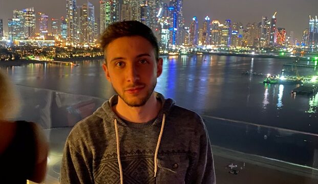 A person standing in front of a city skyline Description automatically generated with medium confidence